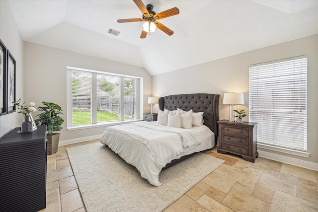 bedroom with baseboards, visible vents, vaulted ceiling, and stone tile flooring