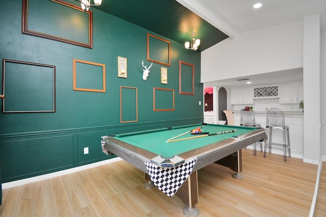 rec room with light wood-type flooring, arched walkways, and pool table