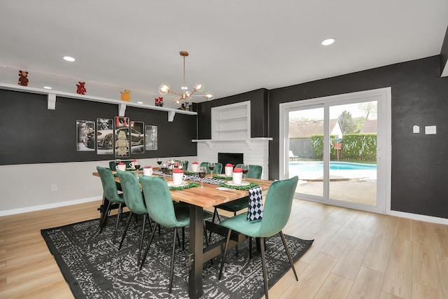 dining area featuring a chandelier, baseboards, light wood-style flooring, and recessed lighting
