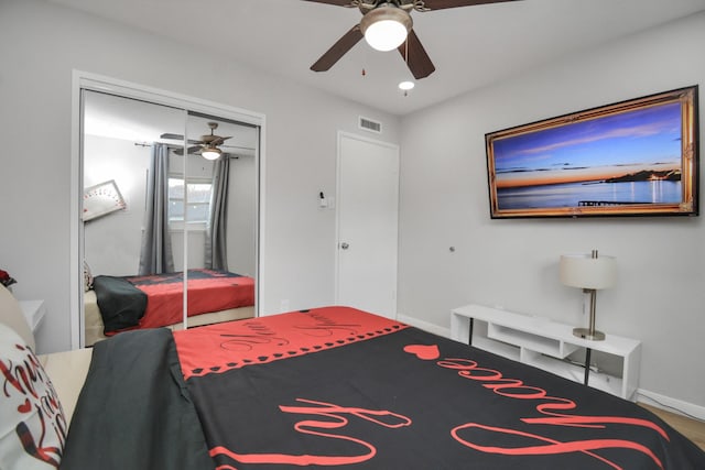 bedroom with ceiling fan, baseboards, and a closet