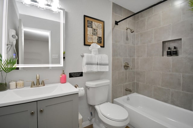bathroom with toilet, vanity, and shower / bathing tub combination