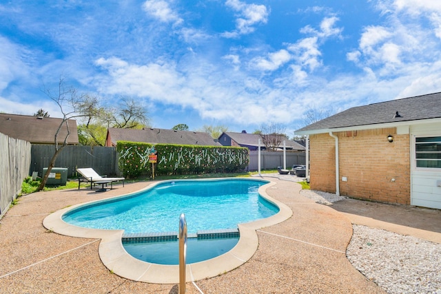 view of pool featuring a fenced in pool, a fenced backyard, and a patio area