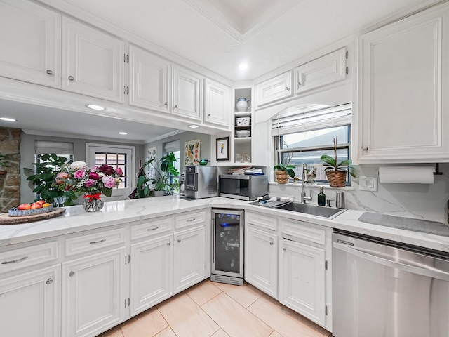 kitchen with beverage cooler, stainless steel appliances, ornamental molding, and a sink