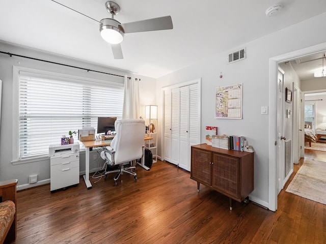 office area featuring attic access, wood finished floors, visible vents, and a ceiling fan