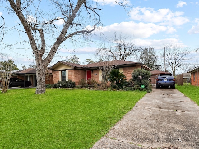 ranch-style home featuring driveway, a front yard, and brick siding