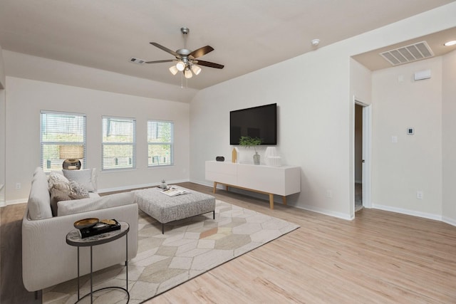 living area featuring a ceiling fan, visible vents, and light wood-style flooring