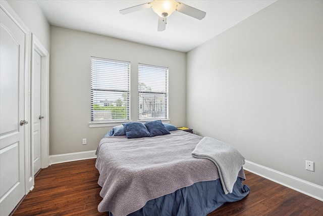 bedroom with a ceiling fan, baseboards, and wood finished floors