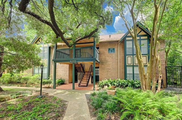 8277 Kingsbrook Rd Unit 254, Houston, TX 77024 - view of front of house with stairway, a deck, and brick siding