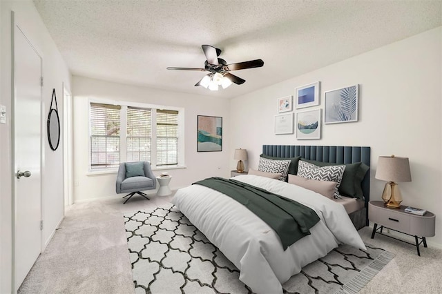 8277 Kingsbrook Rd Unit 254, Houston, TX 77024 - bedroom with a textured ceiling, a ceiling fan, carpet flooring, and baseboards