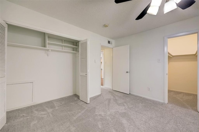 8277 Kingsbrook Rd Unit 254, Houston, TX 77024 - unfurnished bedroom with carpet, visible vents, a ceiling fan, and a closet