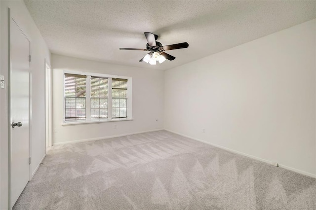 8277 Kingsbrook Rd Unit 254, Houston, TX 77024 - unfurnished bedroom featuring carpet, ceiling fan, baseboards, and a textured ceiling