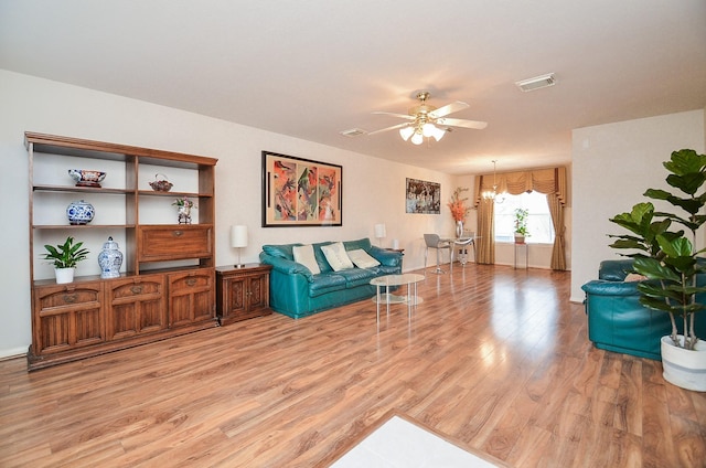 7011 Westover Ridge Dr, Houston, TX 77072 - living room featuring visible vents, light wood finished floors, and ceiling fan with notable chandelier