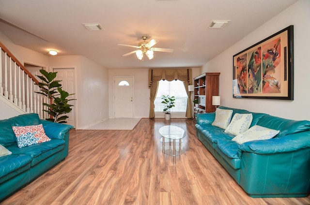 7011 Westover Ridge Dr, Houston, TX 77072 - living area with a ceiling fan, visible vents, stairway, and wood finished floors