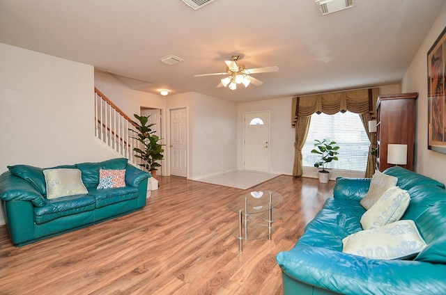 7011 Westover Ridge Dr, Houston, TX 77072 - living area with visible vents, wood finished floors, ceiling fan, and stairs