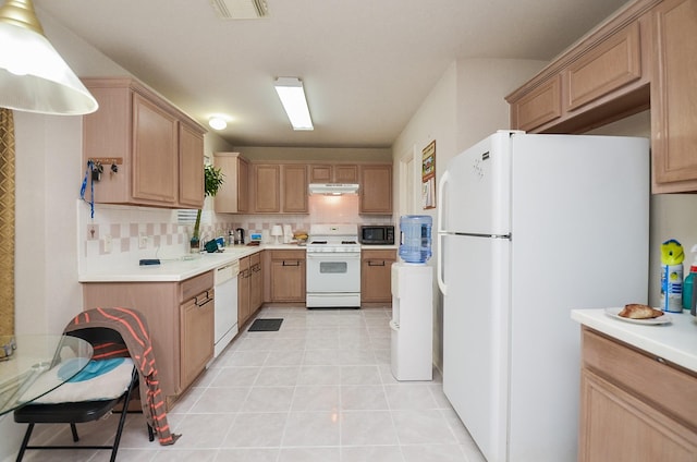 7011 Westover Ridge Dr, Houston, TX 77072 - kitchen with light countertops, light tile patterned flooring, under cabinet range hood, and white appliances