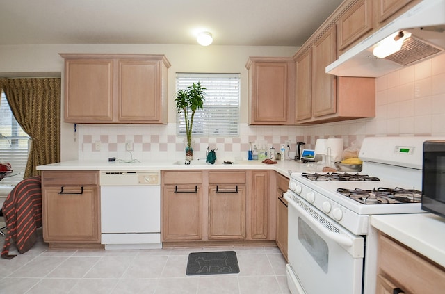 7011 Westover Ridge Dr, Houston, TX 77072 - kitchen featuring a sink, under cabinet range hood, light brown cabinetry, a wealth of natural light, and white appliances