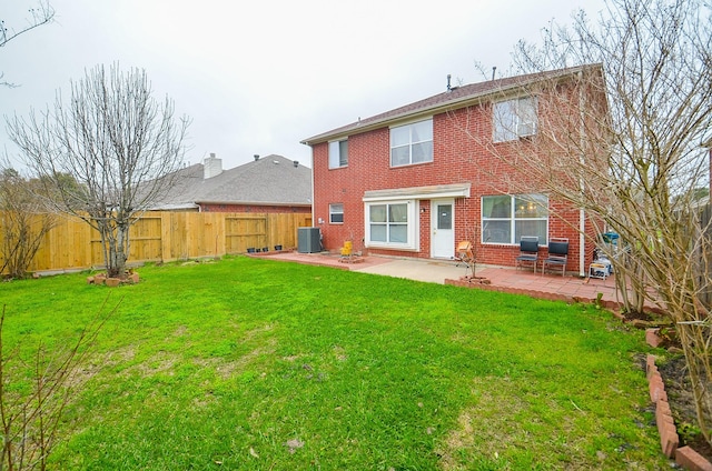 7011 Westover Ridge Dr, Houston, TX 77072 - rear view of house with a patio, central AC unit, a fenced backyard, a lawn, and brick siding