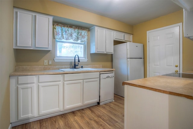 81 Westlake Rd, Trinity, TX 75862 - kitchen featuring a sink, white appliances, light wood-type flooring, and white cabinetry