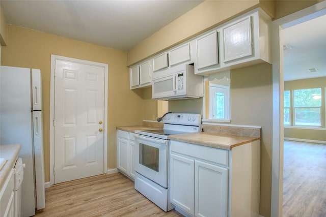 81 Westlake Rd, Trinity, TX 75862 - kitchen featuring white appliances, light wood-type flooring, light countertops, and white cabinetry