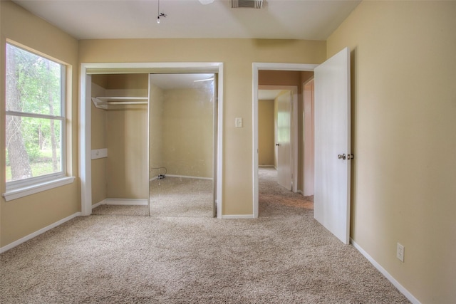 81 Westlake Rd, Trinity, TX 75862 - unfurnished bedroom with carpet floors, multiple windows, a closet, and baseboards