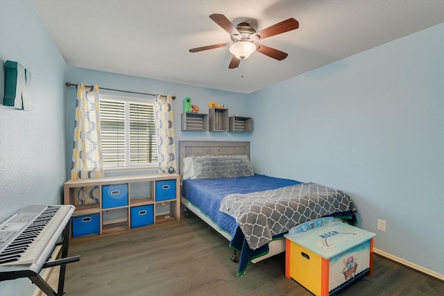 bedroom featuring baseboards, wood finished floors, and a ceiling fan