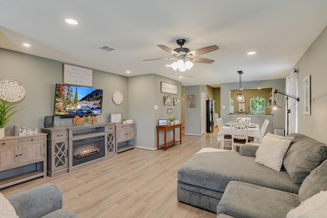 living room featuring visible vents, a ceiling fan, light wood-style flooring, and recessed lighting