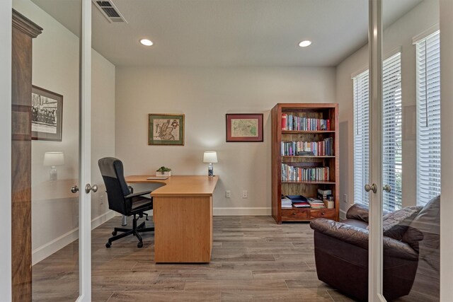 office area with visible vents, baseboards, light wood-style floors, recessed lighting, and french doors