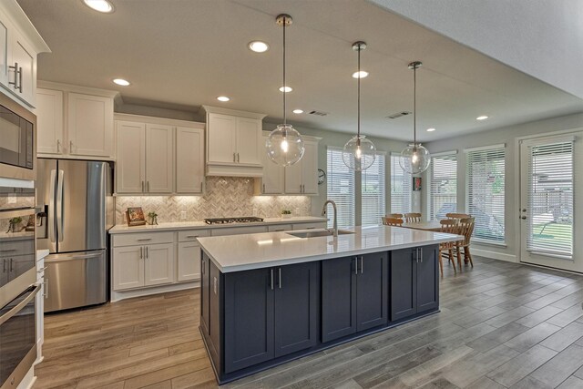 kitchen featuring a sink, white cabinetry, appliances with stainless steel finishes, and light countertops
