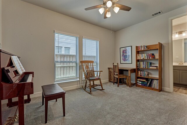 sitting room featuring baseboards, ceiling fan, light carpet, and visible vents