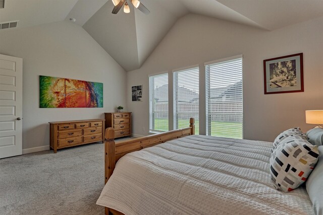 carpeted bedroom featuring a ceiling fan, baseboards, visible vents, and vaulted ceiling