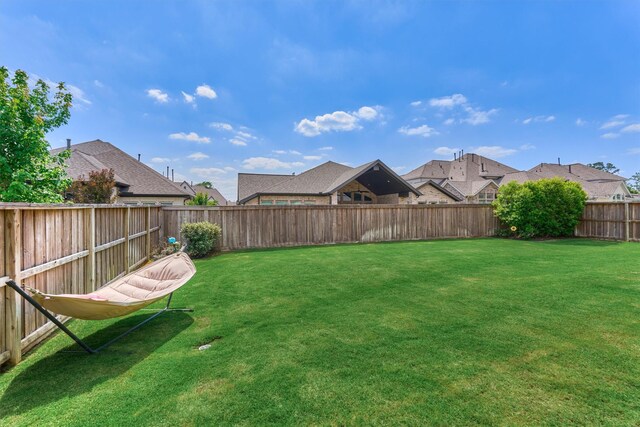 view of yard featuring a residential view and a fenced backyard