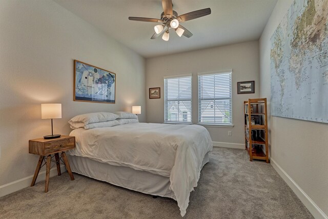 carpeted bedroom with a ceiling fan and baseboards