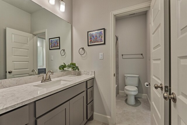 bathroom featuring vanity, baseboards, and toilet