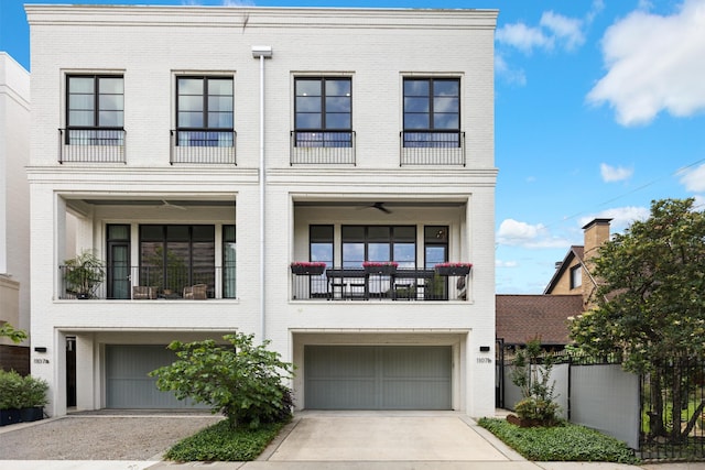 view of front of house featuring driveway, brick siding, fence, a balcony, and an attached garage