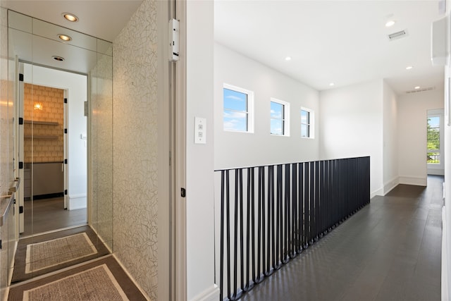 corridor with visible vents, recessed lighting, baseboards, and dark wood finished floors