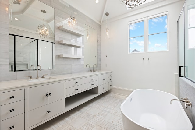 bathroom featuring double vanity, baseboards, a soaking tub, a sink, and a notable chandelier