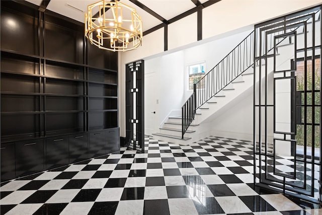 entryway featuring stairway, baseboards, a notable chandelier, and a healthy amount of sunlight