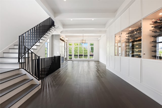 interior space featuring a chandelier, wood finished floors, and stairway