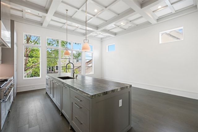 kitchen featuring beamed ceiling, gray cabinets, dark wood finished floors, and a sink