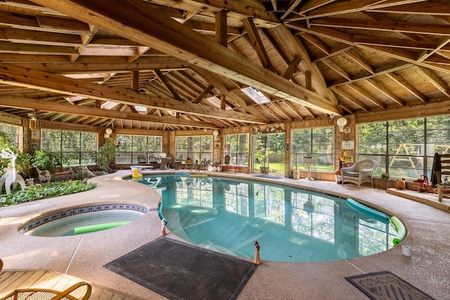 pool with a diving board, fence, an indoor in ground hot tub, and a patio area