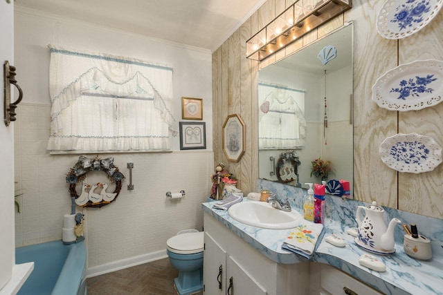 bathroom featuring a tub, brick floor, toilet, vanity, and crown molding