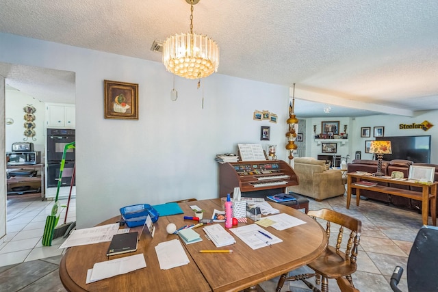 dining area with an inviting chandelier, a textured ceiling, visible vents, and light tile patterned floors