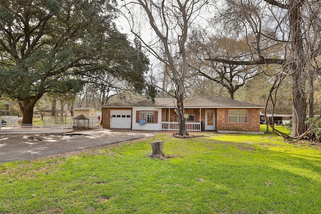 single story home featuring driveway, a front lawn, a porch, and brick siding