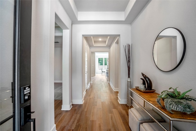 17335 Sunflower Petals Trl, Conroe, TX 77302 - hall featuring baseboards, light wood-type flooring, and a raised ceiling