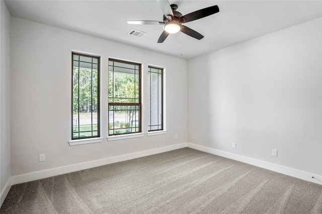 17335 Sunflower Petals Trl, Conroe, TX 77302 - spare room featuring visible vents, baseboards, carpet floors, and a healthy amount of sunlight