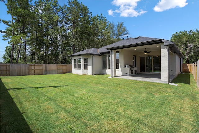 17335 Sunflower Petals Trl, Conroe, TX 77302 - rear view of property with brick siding, ceiling fan, a fenced backyard, and a yard