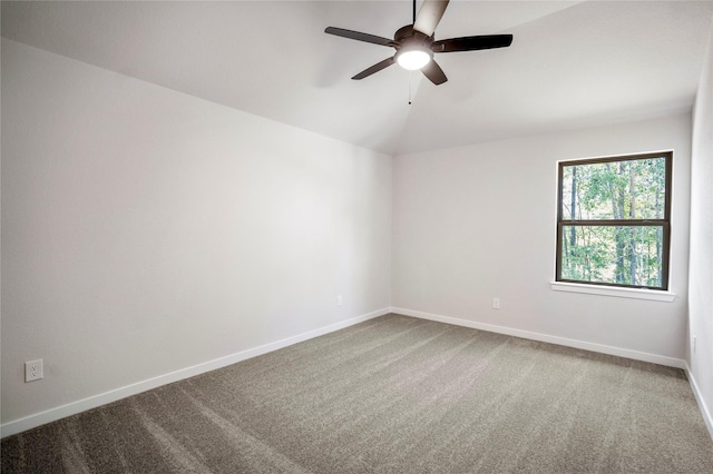 17335 Sunflower Petals Trl, Conroe, TX 77302 - empty room featuring carpet, a ceiling fan, vaulted ceiling, and baseboards