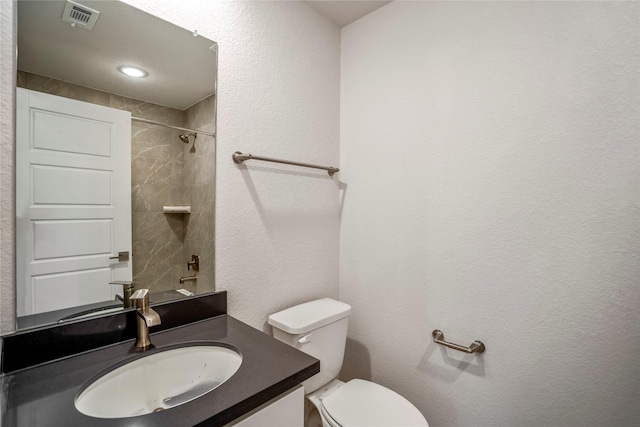 17335 Sunflower Petals Trl, Conroe, TX 77302 - bathroom with toilet, visible vents, a textured wall, and vanity