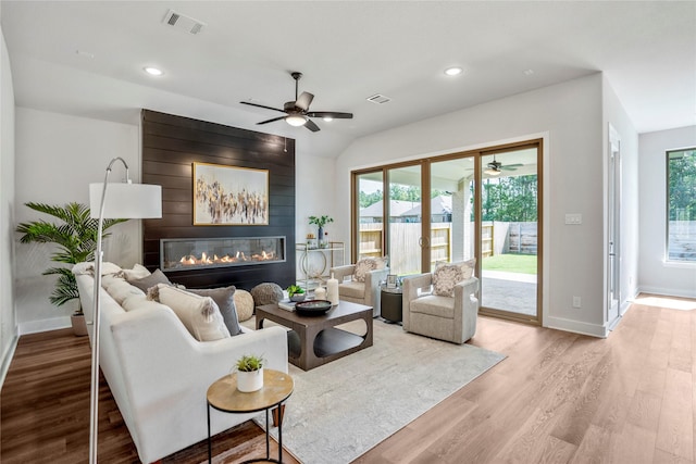 17335 Sunflower Petals Trl, Conroe, TX 77302 - living area featuring wood finished floors, ceiling fan, and a fireplace