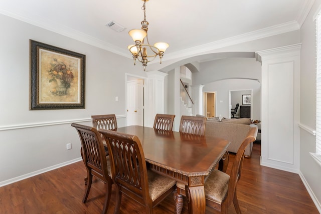 dining area with arched walkways, stairs, decorative columns, dark wood-type flooring, and visible vents